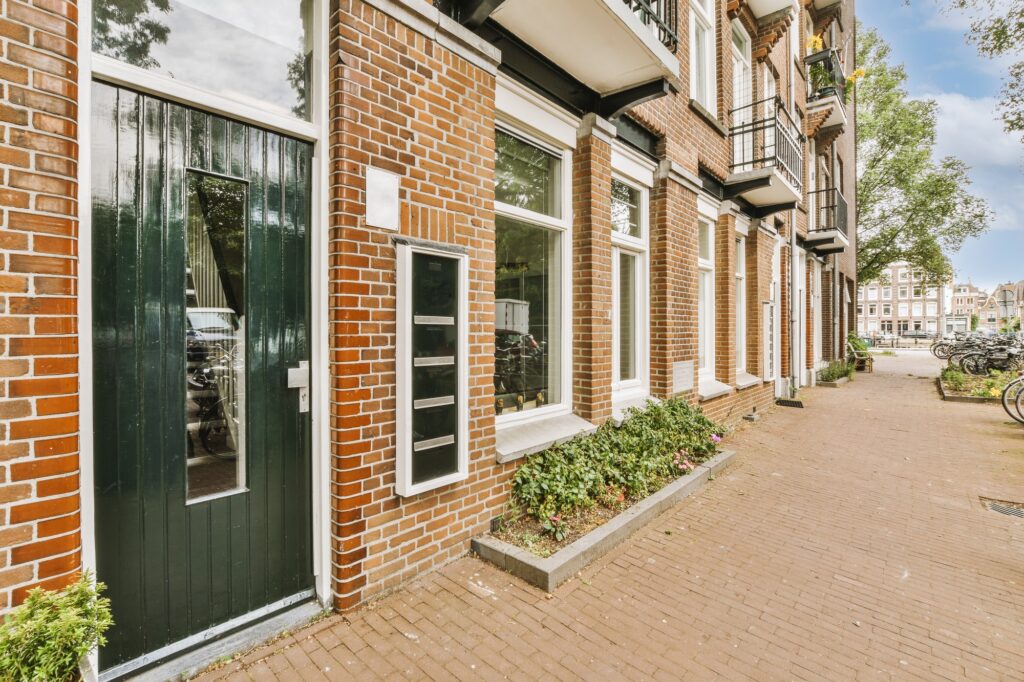 The facade of a brick building with wooden door